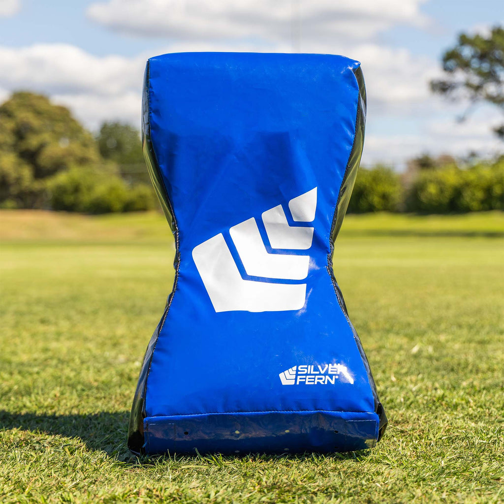 Defence Curved Hit Shield, lifestyle shot, hit shield sitting on the grass by itself.