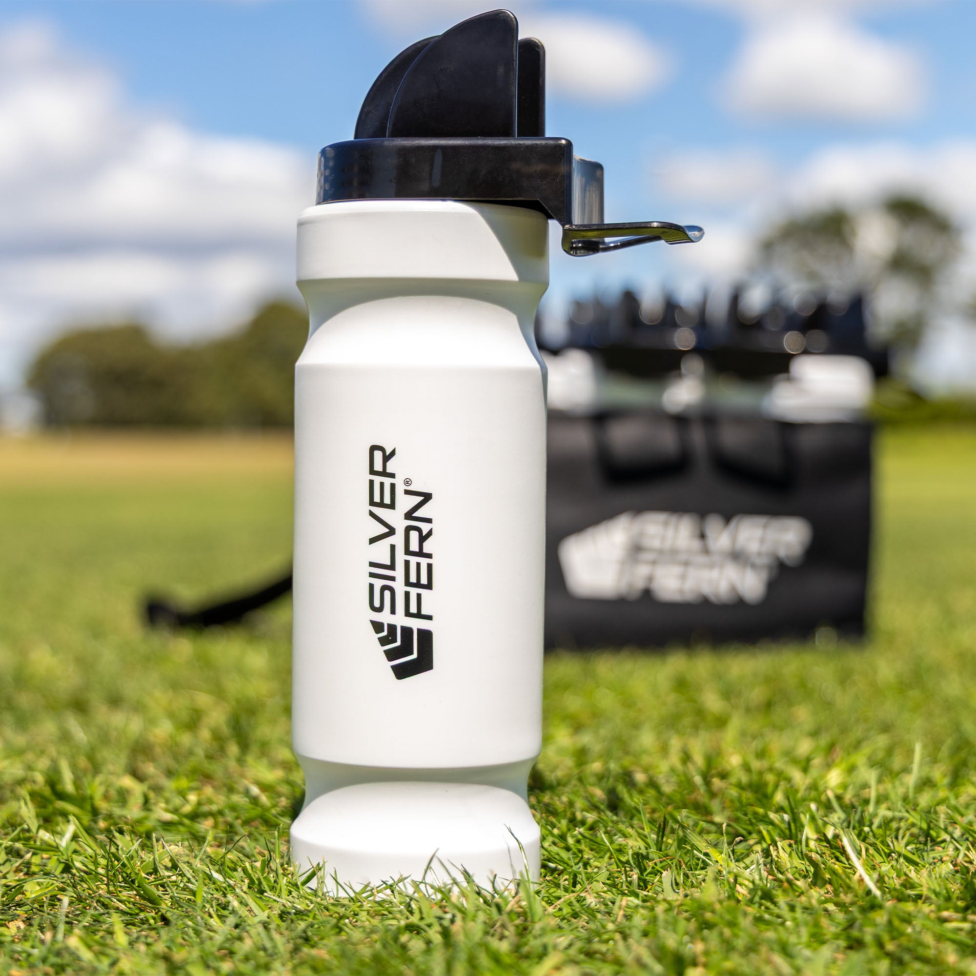 Hygiene drink bottle, lifestyle shot, drink bottle on its own sitting on the grass, lifestyle.