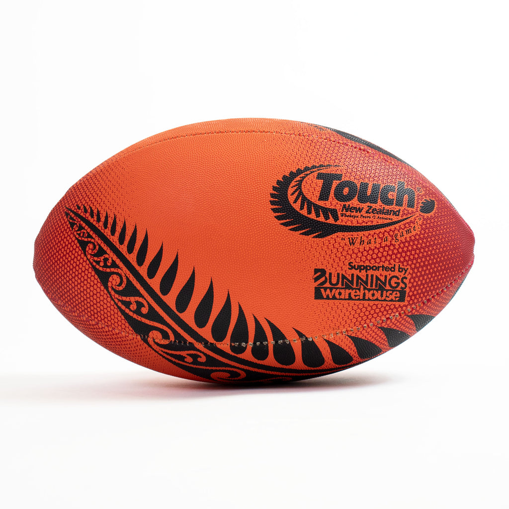 Orange rugby ball with black patterns and branding on a white background