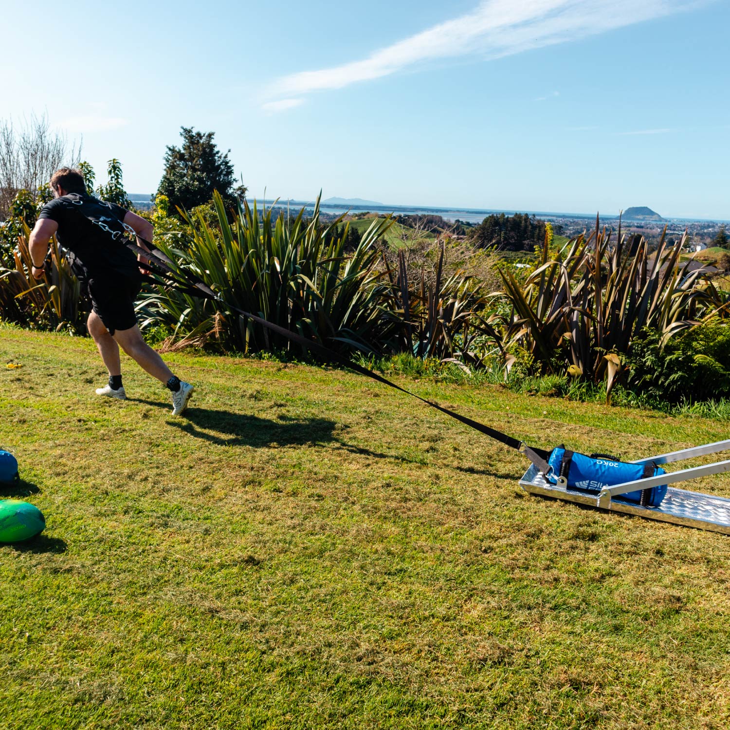 Rugby Scrum/Ruck Harness Set being used in action, draggin a scrum sled with weighted bags, lifestyle shot