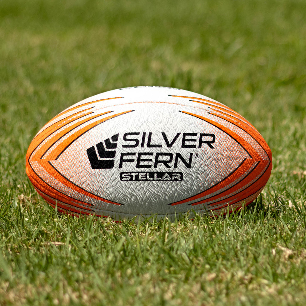 Silver Fern Stellar Premium Trainer Size 2.5, Lifestyle shot, sitting on a rugby field