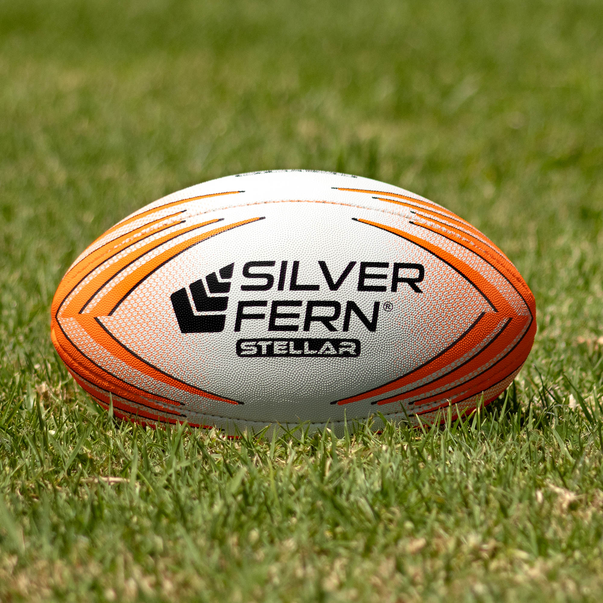 Silver Fern Stellar Premium Trainer Size 2.5, Lifestyle shot, sitting on a rugby field