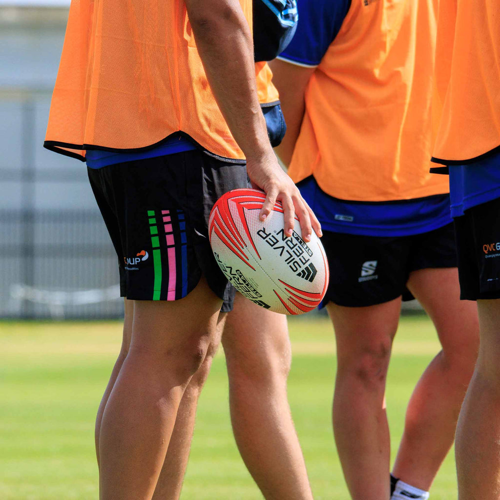 Silver Fern Rugby Premium Trainer Stellar Ball, Red, Size 5, player holding ball, lifestyle.