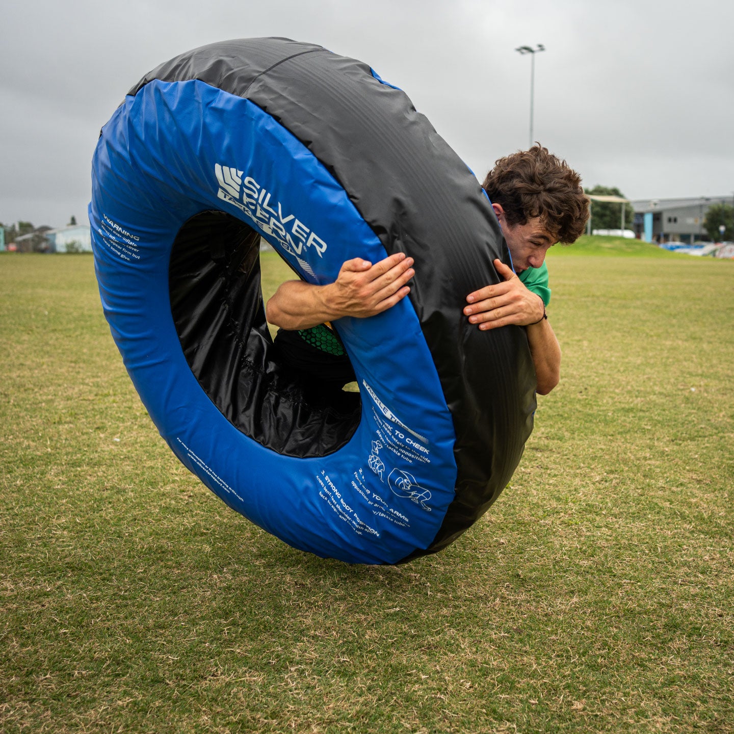Silver Fern Tackle Tube, lifestyle shot, rugby player tackling the tackle tube.