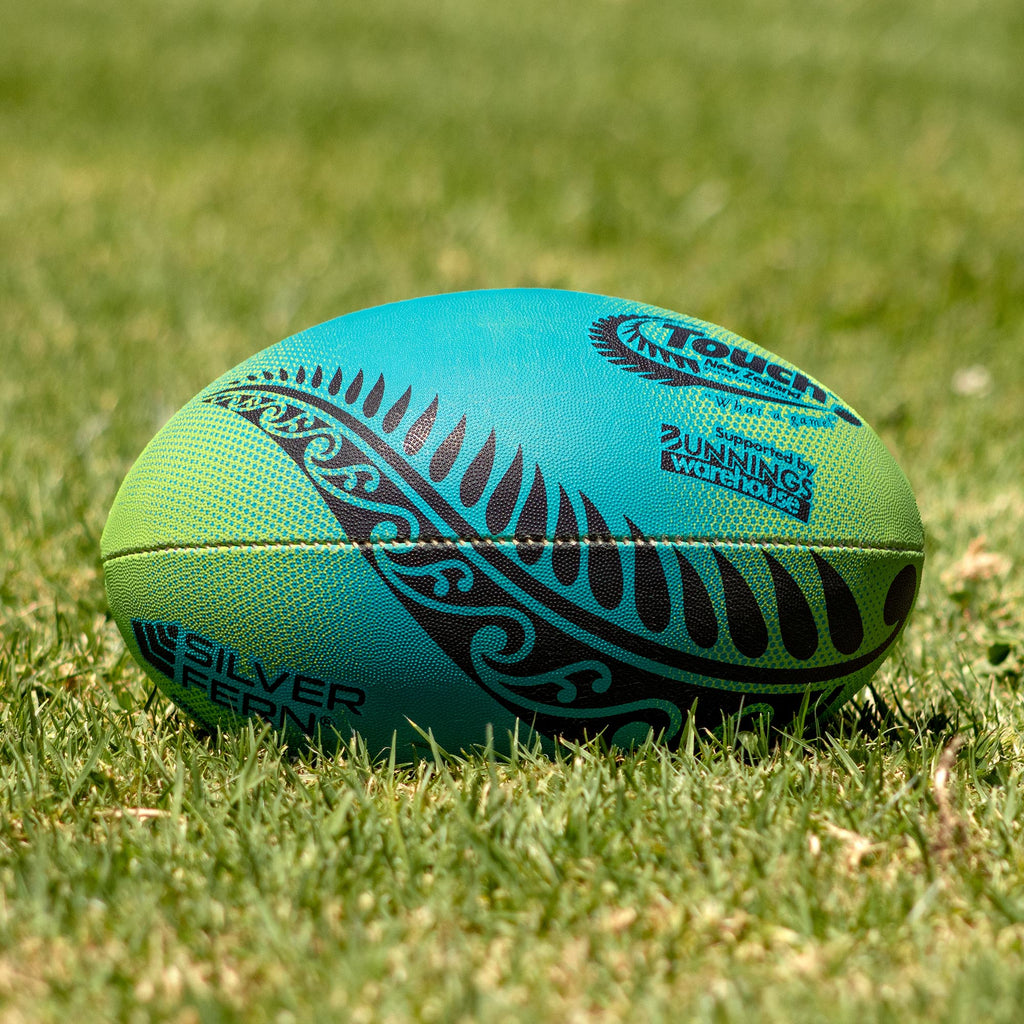 Silver Fern Touch Rugby Ball Ocean Force Trainer, Lifestyle shot, sitting on a rugby field